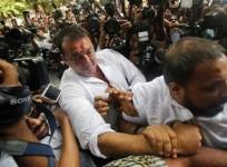 bollywood-actor-sanjay-dutt-is-escorted-by-his-security-staff-as-he-arrives-to-surrender-at-a-court-in-mumbai-may-16-2013