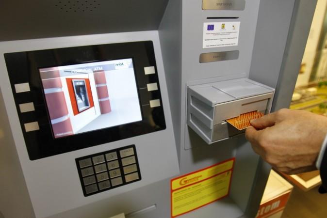Malaysian Robbers Drag out and Carry Away ATM (Credit: Reuters)