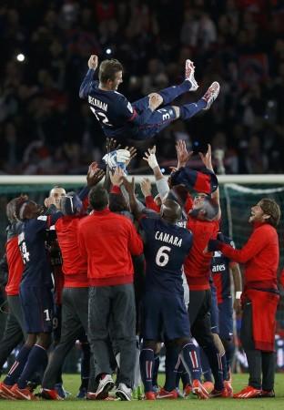 Paris Saint-Germain players throw David Beckham in the air at the end of their team's French Ligue 1 soccer match against Brest at the Parc des Princes stadium in Paris David Beckham