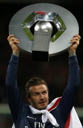 Paris Saint-Germain Beckham raises the French Championship trophy at the end of their team's French Ligue 1 soccer match against Brest at the Parc des Princes stadium in Paris David Beckham