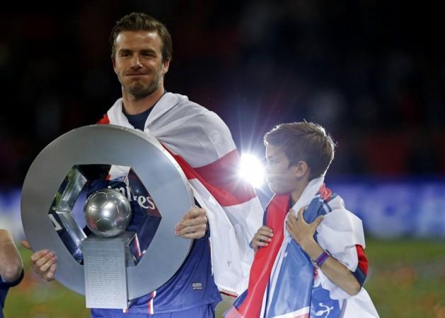 Paris Saint-Germain Beckham raises the French Championship trophy at the end of their team's French Ligue 1 soccer match against Brest at the Parc des Princes stadium in Paris David Beckham
