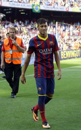 Neymar smiles to Barcelona's supporters at his presentation after signing a five-year contract with the club, at Nou Camp stadium in Barcelona Neymar