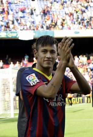 Neymar acknowledges Barcelona's supporters at his presentation after signing a five-year contract with the club, at Nou Camp stadium in Barcelona Neymar