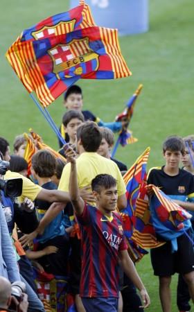 Neymar waves flags Barcelona's flags as he acknowledges the fans at his presentation after signing a five-year contract with the club, at Nou Camp stadium in Barcelona Neymar