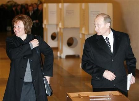 Russia's President Vladimir Putin (R) and his wife Lyudmila take part in the presidential election at a polling station in Moscow March 2, 2008.
