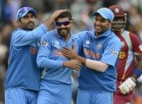 india-spinner-ravindra-jadeja-is-congratulated-by-dinesh-karthik-and-rohit-sharma-after-picking-up-the-wicket-of-west-indies-batsman-ravi-rampaul-in-their-icc-champions-trophy-2013-game-reuters
