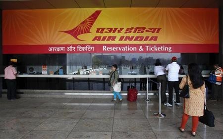 Customers stand at an Air India reservation office at the domestic airport in Mumbai