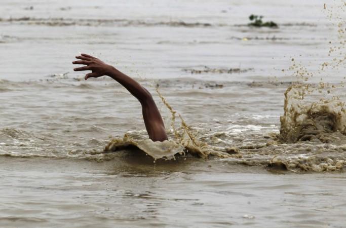 A man swims in the flooded waters of river Yamuna to retrieve floating watermelons in New Delhi (Reuters) North India Flood