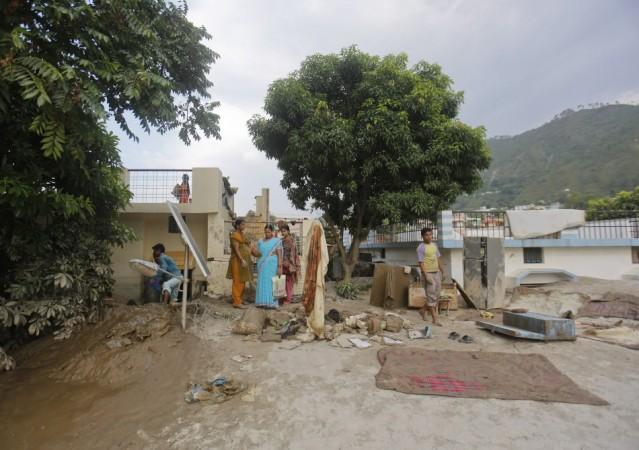 Residents take out their personal belongings from houses submerged in sand due to floods in Srinagar in the Himalayan state of Uttarakhand. (Reuters) North India Flood
