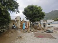 Residents take out their personal belongings from houses submerged in sand due to floods in Srinagar in the Himalayan state of Uttarakhand June 19, 2013.