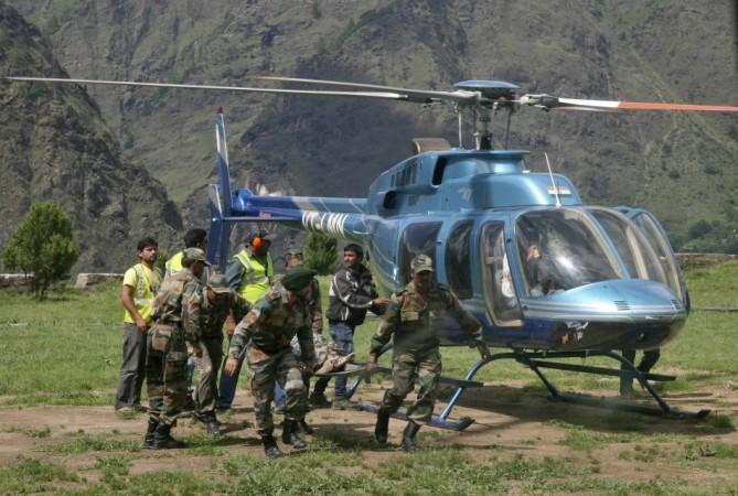 Soldiers carry the body of a flood victim after heavy rains in the Himalayan state of Uttarakhand(Reuters)