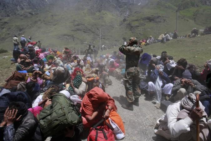 People and soldiers cover their faces as an army helicopter lands during rescue operations at Badrinath in the Himalayan state of Uttarakhand June 21, 2013. (Reuters) North India Floods
