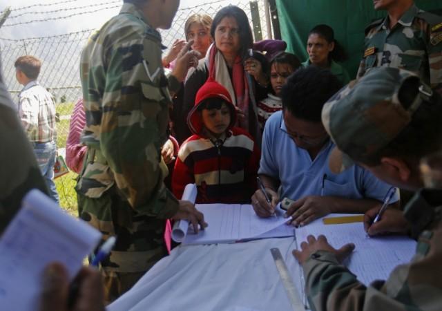 A boy has his details noted by soldiers after getting off from an army helicopter with other survivors at Joshimath in the Himalayan state of Uttarakhand June 21, 2013. (Reuters) North India Floods