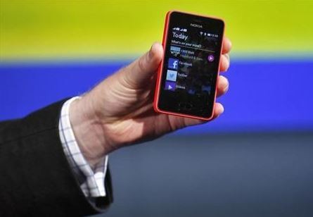 A Nokia official displays a new $99 phone in its mid-range Asha line at a launch in New Delhi May 9, 2013.