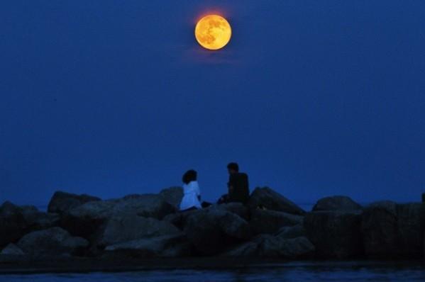 The moon is seen in an abnormally red colour as it rises in the Toronto Beaches. (Reuters) Supermoon