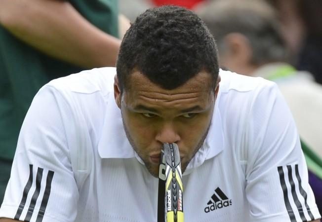 Jo-Wilfried Tsonga of France reacts as he sits in his seat after losing the second set in his men's singles tennis match against Ernests Gulbis of Latvia at the Wimbledon Tennis Championships, in London Jo-Wilfried Tsonga