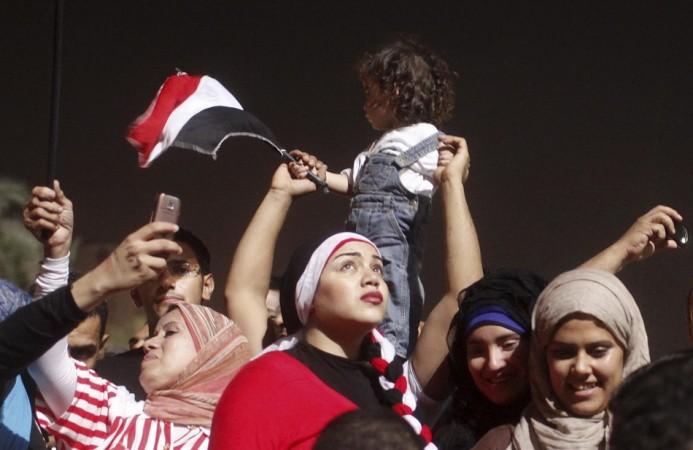 An anti-Mursi protester looks on as people celebrate in Tahrir square after the announcement of the removal from office of Egypt's deposed President Mursi in Cairo Egypt