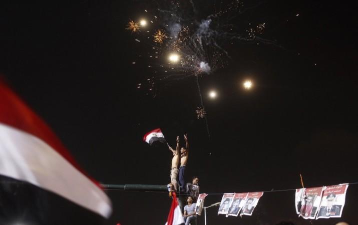 Anti-Mursi protesters celebrate in Tahrir square after the announcement of the removal from office of Egypt's deposed President Mohamed Mursi in Cairo Egypt