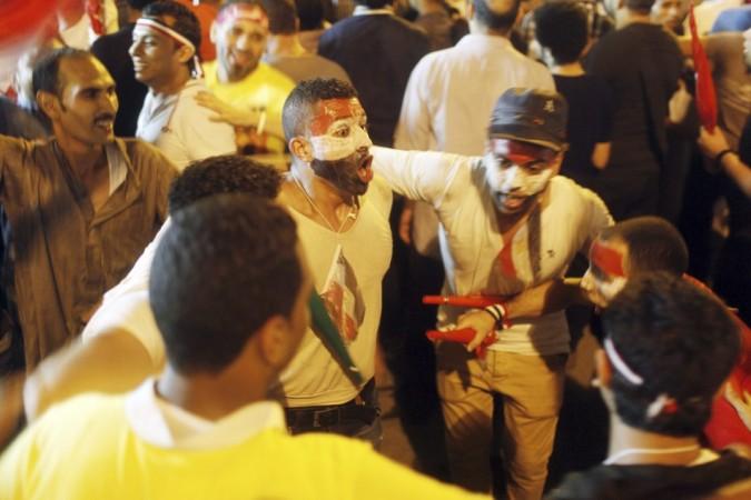 Anti-Mursi protesters dance as they celebrate near Tahrir square after the announcement of the removal from office of Egypt's deposed President Mohamed Mursi Egypt