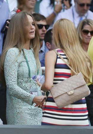Kim Sears, the girlfriend of Andy Murray of Britain shakes hands with Jelena Ristic, the girlfriend of Novak Djokovic of Serbia, on Centre Court before the men's singles final tennis match at the Wimbledon Tennis Championships, in London Kim Sears, Jelena Ristic