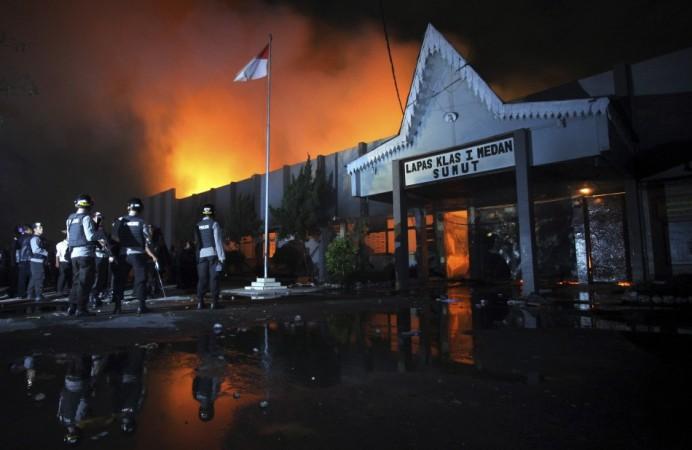 Police officers stand guard outside Tanjung Gusta prison, which was set ablaze by inmates after a riot broke out, in Medan in North Sumatra province (Reuters) Police officers stand guard outside Tanjung Gusta prison, which was set ablaze by inmates after a riot broke out, in Medan in North Sumatra province(Reuters)