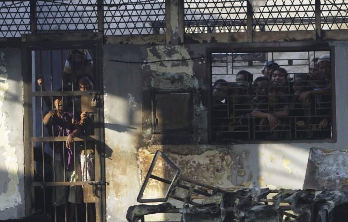Prisoners stand inside the burned Tanjung Gusta prison, which was set ablaze by inmates after a riot broke out, in Medan in North Sumatra province(Reuters)