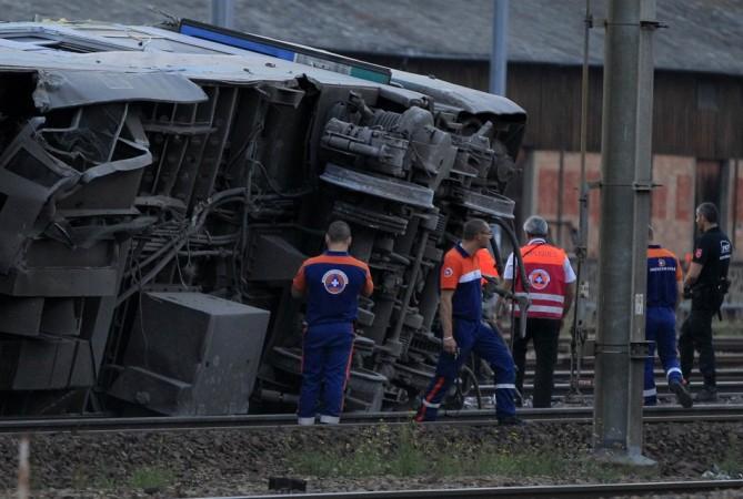 Rescue workers stand next to the wreckage of a derailed intercity train at the Bretigny-sur-Orge station near Paris(Reuters) Rescue workers stand next to the wreckage of a derailed intercity train at the Bretigny-sur-Orge station near Paris(Reuters)