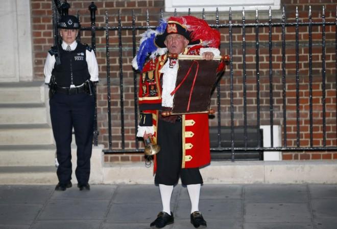 A town crier announces the royal birth outside the Lindo Wing of St Mary's Hospital after Catherine, Duchess of Cambridge gave birth to a baby boy in central London Royal Baby