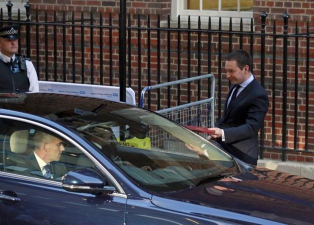 Ed Perkins of Kensington Palace hands over the official birth notice to a waiting driver outside the Lindo wing of St Mary's Hospital after Catherine, Duchess of Cambridge gave birth to a boy in central London Royal Baby