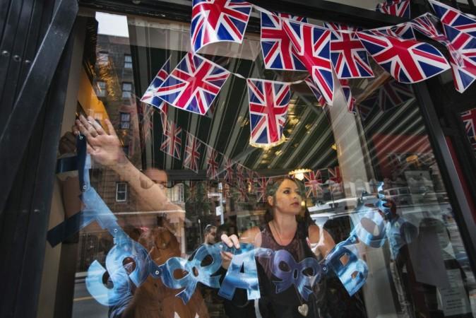 Employees hang sign on store celebrating news of a son from Britain's Catherine, Duchess of Cambridge, in New York Royal Baby