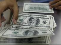 a-woman-counts-u-s-dollars-at-a-money-changer