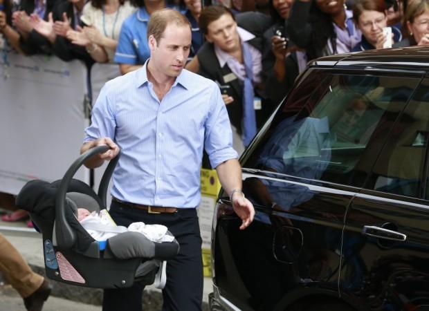 Britain's Prince William carries his baby son in a car seat, as he leaves the Lindo Wing of St Mary's Hospital with his wife Catherine, Duchess of Cambridge, in central London Royal Baby