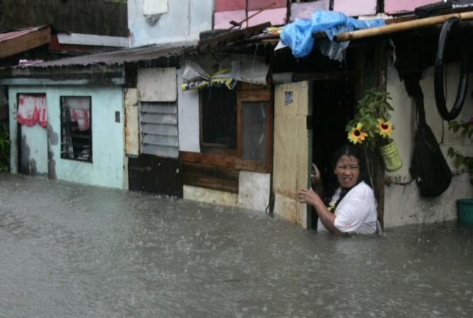 A woman wades in floodwaters. (representational image)