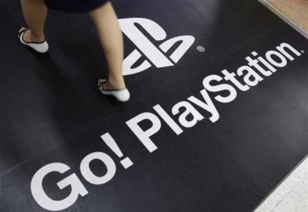 A woman walks on a floor advertisement for Sony Corp's PlayStation 3 game console at an electronic store in Tokyo April 27, 2011. REUTERS/Yuriko Nakao