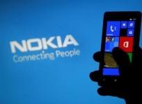 a-woman-poses-with-a-nokia-lumia-smartphone-in-this-photo-illustration-in-the-central-bosnian-town-of-zenica-may-6-2013