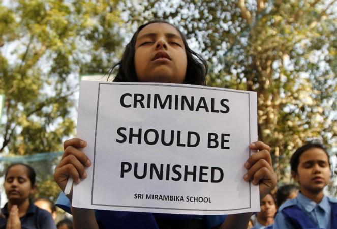 Schoolgirls pray to pay homage to a rape victim who was assaulted and gang raped in New Delhi on 16 December, 2012. The gang rape sparked protests and a national debate about violence against women in India. The four accused were found guilty of the crime