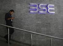 an-employee-walks-out-of-the-bombay-stock-exchange-bse-building-in-mumbai-august-22-2013