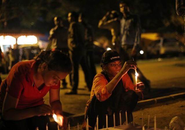 Demonstrators light candles during a candle light vigil after four men convicted of raping and murdering a 23-year-old woman in Delhi were sentenced to death in New Delhi Delhi Gang-rape case