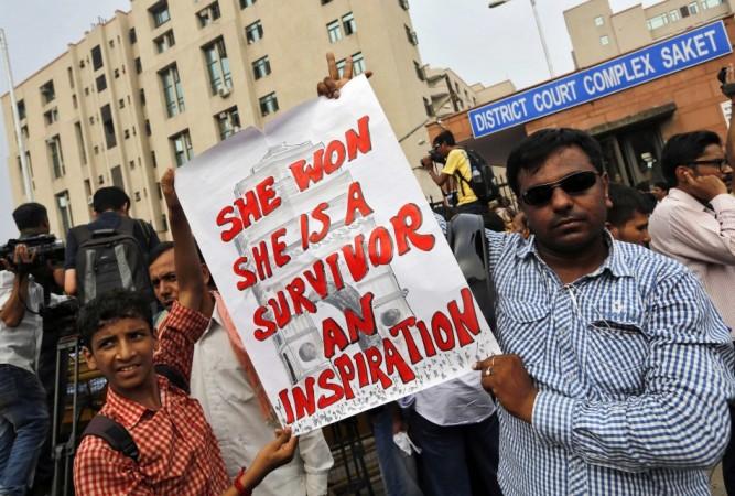 Demonstrators hold a placard outside a court in New Delhi Delhi gang-rape case