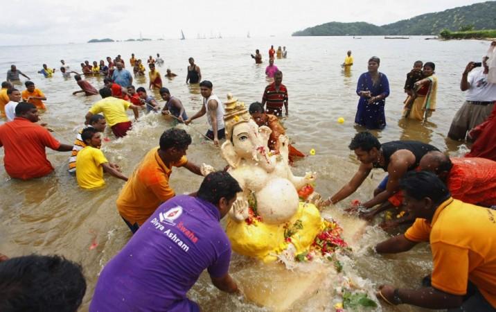 Hindu devotees pull a murti of Lord Ganesha to be submerged in water during the Ganesh Utsav festival. Ganpati visarjan