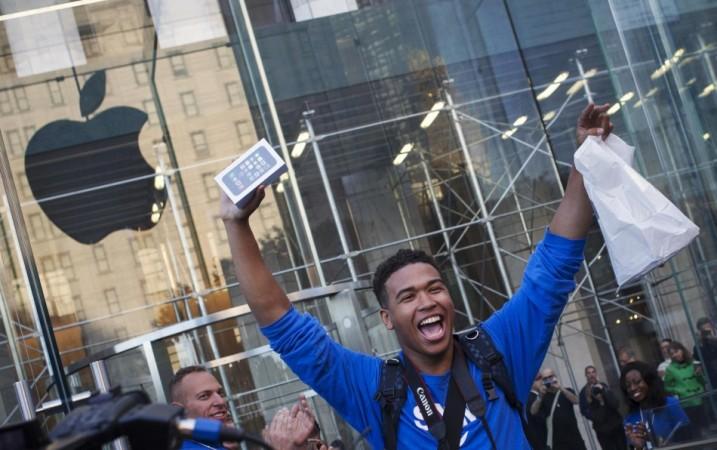 One of the first customers to purchase the Apple iPhone 5S celebrates after exiting the Apple Retail Store on Fifth Avenue in Manhattan iPhone 5S