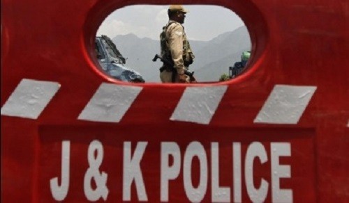 File photo of a policeman behind a barricade during a general strike in Srinagar, June 25, 2013.