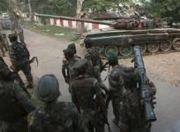 a-tank-from-the-indian-army-moves-past-soldiers-during-a-search-operation-after-a-gun-battle-at-an-army-camp-in-mesar-in-samba-district-september-26-2013