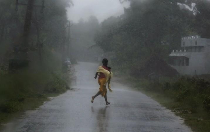 A girl runs for shelter in heavy rain brought by Cyclone Phailin in Ichapuram Cyclone Phailin