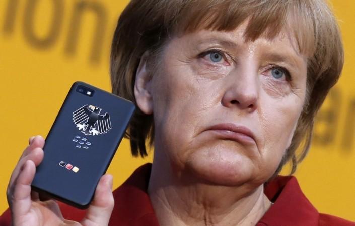 German Chancellor Angela Merkel holds a BlackBerry Z10 smartphone last year, as it was revealed that the NSA had been listening in on her telephone conversations. (Credit: Reuters) NSA Spying on Angela Merkel