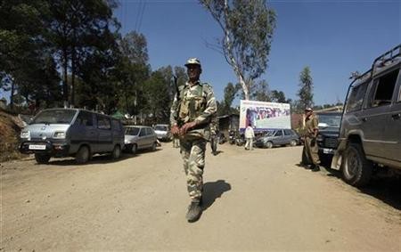 Security force personnel patrol a road at a village in the Chandel district,Imphal January 23, 2012.