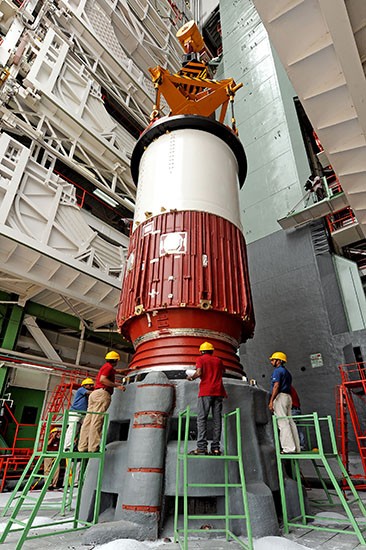 1 First Stage nozzle end segment being placed on launch pedestal 1 First Stage nozzle end segment being placed on launch pedestal