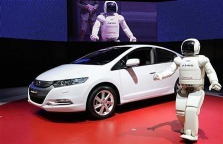 Honda's humanoid robot ''Asimo'' unveils the new Honda Insight hybrid car during the first media day of the 79th Geneva Car Show at the Palexpo in Geneva March 3, 2009. Honda Insight