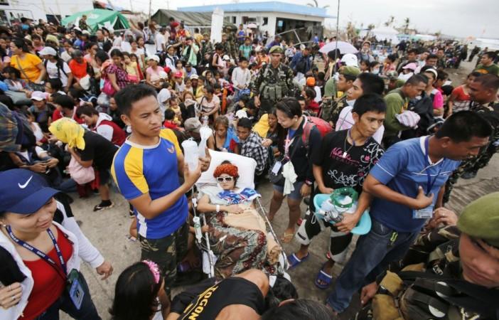 An injured woman waits to be transported to Manila in the aftermath of typhoon Haiyan in Tacloban Typhoon Haiyan