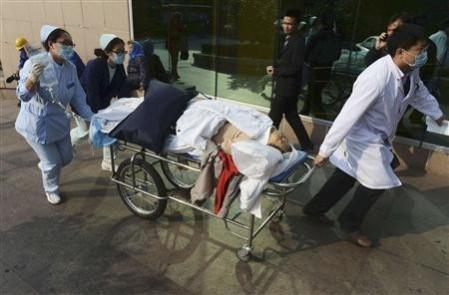 An injured woman being rushed to the hospital in China An injured woman being rushed to the hospital in China